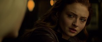 Movie still from “Dark Phoenix” (2019), directed by Simon Kinberg – A woman's face with lights in the background; Close Up shot, Over the shoulder angle