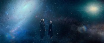 Movie still from “Dark Phoenix” (2019), directed by Simon Kinberg – Two women standing next to each other in a dark space; Wide shot, Overhead angle