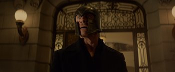 Movie still from “Dark Phoenix” (2019), directed by Simon Kinberg – A man wearing a helmet is standing in front of a door; Close Up shot, Low angle