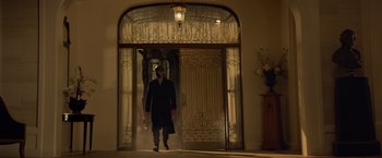 Movie still from “Dark Phoenix” (2019), directed by Simon Kinberg – A man walking in front of an entrance to a house; Wide shot, Low angle