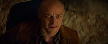 Movie still from “Dark Phoenix” (2019), directed by Simon Kinberg – A man with a bald head is looking at the camera; Close Up shot, Low angle