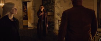 Movie still from “Dark Phoenix” (2019), directed by Simon Kinberg – A woman standing in front of a mirror in a dark room; Medium shot, Over the shoulder angle