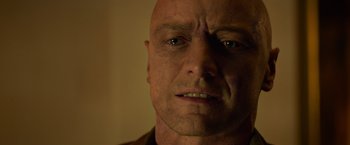Movie still from “Dark Phoenix” (2019), directed by Simon Kinberg – A man's face in a dark room; Close Up shot, Low angle
