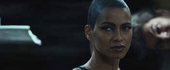 Movie still from “Dark Phoenix” (2019), directed by Simon Kinberg – A person with short black hair; Close Up shot, Over the shoulder angle