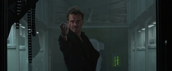 Movie still from “Dark Phoenix” (2019), directed by Simon Kinberg – A man in a black shirt is holding a marker; Medium shot, Low angle