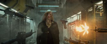 Movie still from “Dark Phoenix” (2019), directed by Simon Kinberg – A woman in a black jacket and a white mask; Medium shot, Over the shoulder angle