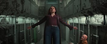 Movie still from “Dark Phoenix” (2019), directed by Simon Kinberg – A woman standing in a hallway with her arms outstretched; Medium shot, Low angle