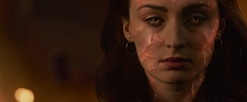 Movie still from “Dark Phoenix” (2019), directed by Simon Kinberg – A person's face with a crack in it; Close Up shot, Over the shoulder angle