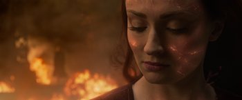 Movie still from “Dark Phoenix” (2019), directed by Simon Kinberg – A woman's face in front of a fire; Close Up shot, Over the shoulder angle