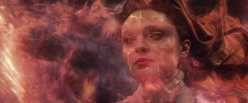 Movie still from “Dark Phoenix” (2019), directed by Simon Kinberg – A woman with red and purple smoke coming out of her face; Close Up shot, Overhead angle