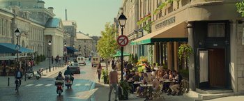 Movie still from “Dark Phoenix” (2019), directed by Simon Kinberg – A group of people sitting at tables on a sidewalk; Extreme Wide shot, High angle