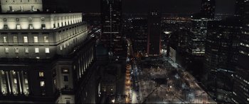 Movie still from “To Catch a Killer” (2023), directed by Damián Szifron – An aerial view of a city at night with lights; Extreme Wide shot, High angle