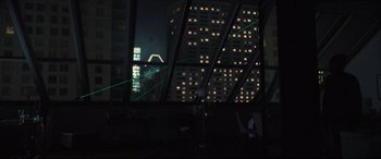 Movie still from “To Catch a Killer” (2023), directed by Damián Szifron – A view of a city at night through a window; Extreme Wide shot, Low angle
