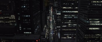 Movie still from “To Catch a Killer” (2023), directed by Damián Szifron – An aerial view of a city street at night; Extreme Wide shot, High angle