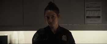 Movie still from “To Catch a Killer” (2023), directed by Damián Szifron – A police officer in uniform looking at the camera; Close Up shot, Low angle