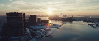 Movie still from “To Catch a Killer” (2023), directed by Damián Szifron – An aerial view of a harbor with a sunset in the background; Extreme Wide shot, Low angle