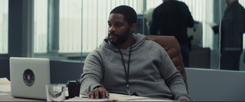 Movie still from “To Catch a Killer” (2023), directed by Damián Szifron – A man sitting at a table in a room; Medium shot, Over the shoulder angle