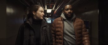 Movie still from “To Catch a Killer” (2023), directed by Damián Szifron – A man and a woman walking down a train platform; Medium shot, Low angle