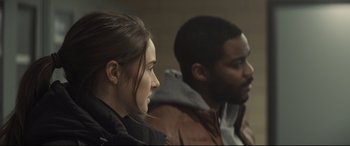 Movie still from “To Catch a Killer” (2023), directed by Damián Szifron – A woman and a man sitting next to each other; Close Up shot, Over the shoulder angle