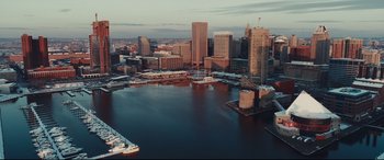 Movie still from “To Catch a Killer” (2023), directed by Damián Szifron – An aerial view of a harbor with a city skyline in the background; Extreme Wide shot, High angle