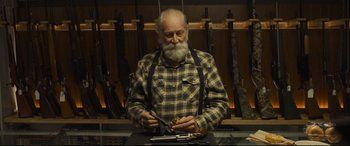 Movie still from “To Catch a Killer” (2023), directed by Damián Szifron – An older man holding a knife in his hands; Medium shot, Low angle