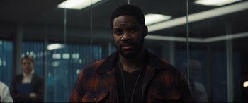 Movie still from “To Catch a Killer” (2023), directed by Damián Szifron – A man in a plaid jacket standing in front of a mirror; Close Up shot, Over the shoulder angle