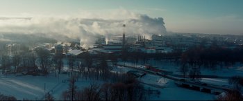Movie still from “To Catch a Killer” (2023), directed by Damián Szifron – An aerial view of an industrial area in the winter; Extreme Wide shot, High angle