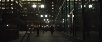 Movie still from “To Catch a Killer” (2023), directed by Damián Szifron – A man walking down a sidewalk at night; Extreme Wide shot, Low angle