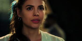 Movie still from “Dark Web: Cicada 3301” (2021), directed by Alan Ritchson – A woman's face in a white shirt; Close Up shot, Over the shoulder angle
