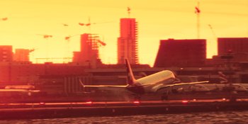 Movie still from “Dark Web: Cicada 3301” (2021), directed by Alan Ritchson – An airplane is taking off from the runway; Extreme Wide shot, Low angle