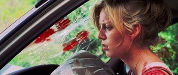 Movie still from “Dawn of the Dead” (2004), directed by Zack Snyder – A woman sitting in the driver's seat of a car; Close Up shot, Low angle