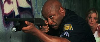 Movie still from “Dawn of the Dead” (2004), directed by Zack Snyder – A police officer holding a gun in his hand; Close Up shot, Low angle