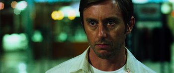 Movie still from “Dawn of the Dead” (2004), directed by Zack Snyder – A person wearing a white shirt; Close Up shot, Over the shoulder angle