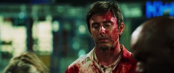 Movie still from “Dawn of the Dead” (2004), directed by Zack Snyder – A man with blood all over his face and neck; Close Up shot, Low angle