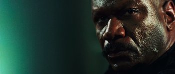 Movie still from “Dawn of the Dead” (2004), directed by Zack Snyder – A man's face in a darkened room; Close Up shot, Low angle