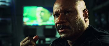 Movie still from “Dawn of the Dead” (2004), directed by Zack Snyder – A person in a police uniform; Close Up shot, Over the shoulder angle