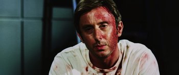 Movie still from “Dawn of the Dead” (2004), directed by Zack Snyder – A person with blood on his face; Close Up shot, Over the shoulder angle