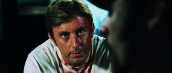 Movie still from “Dawn of the Dead” (2004), directed by Zack Snyder – A person with blood on his face; Close Up shot, Over the shoulder angle