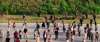 Movie still from “Dawn of the Dead” (2004), directed by Zack Snyder – A group of people walking across a street; Extreme Wide shot, High angle