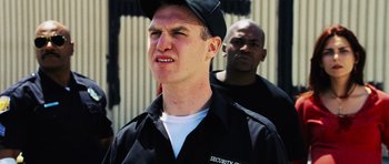 Movie still from “Dawn of the Dead” (2004), directed by Zack Snyder – A man in a security uniform and a man in a baseball cap; Close Up shot, Low angle