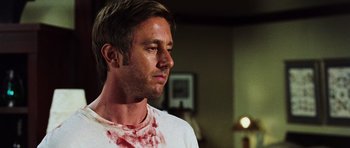 Movie still from “Dawn of the Dead” (2004), directed by Zack Snyder – A person with blood on his face; Close Up shot, Over the shoulder angle