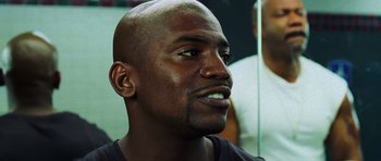 Movie still from “Dawn of the Dead” (2004), directed by Zack Snyder – A man's face with a bald head; Close Up shot, Over the shoulder angle