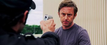 Movie still from “Dawn of the Dead” (2004), directed by Zack Snyder – A man taking a picture of another man holding a camera; Close Up shot, Over the shoulder angle