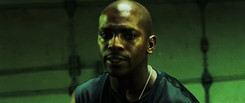 Movie still from “Dawn of the Dead” (2004), directed by Zack Snyder – A person wearing a necklace; Close Up shot, Low angle