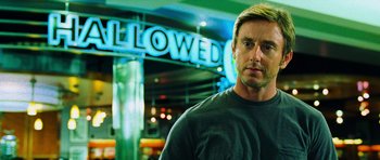 Movie still from “Dawn of the Dead” (2004), directed by Zack Snyder – A person in front of a building; Close Up shot, Low angle