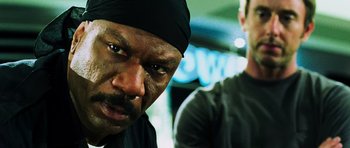 Movie still from “Dawn of the Dead” (2004), directed by Zack Snyder – A person with a black hat; Close Up shot, Low angle