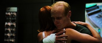 Movie still from “Dawn of the Dead” (2004), directed by Zack Snyder – A man and a woman hugging in a dark room; Close Up shot, Low angle