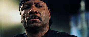 Movie still from “Dawn of the Dead” (2004), directed by Zack Snyder – A person wearing a police uniform; Close Up shot, Low angle