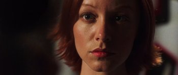 Movie still from “Dawn of the Dead” (2004), directed by Zack Snyder – A woman's face with red hair and green eyes; Close Up shot, Low angle