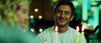 Movie still from “Dawn of the Dead” (2004), directed by Zack Snyder – A man sitting in front of a lit candle; Close Up shot, Over the shoulder angle